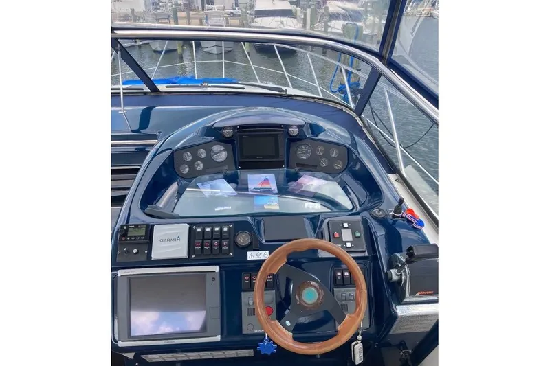 Slide: The Image of Cockpit of 2001 Sealine S41 Sports Cruiser with navigation equipment and wooden steering wheel. - 8
