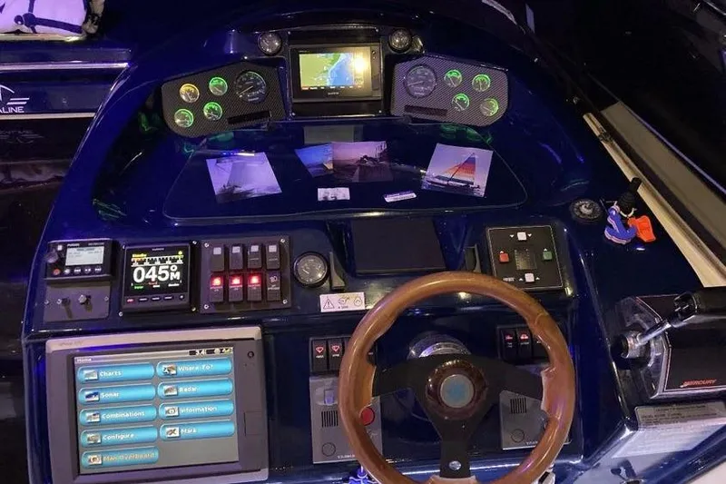 Slide: The Image of Control panel of a 2001 Sealine S41 Sports Cruiser with navigation and steering features. - 9