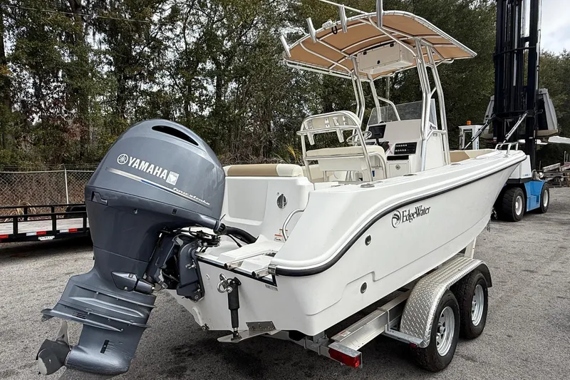 Slide: The Image of 2020 Edgewater 208CC boat with Yamaha outboard motor on a trailer. - 1