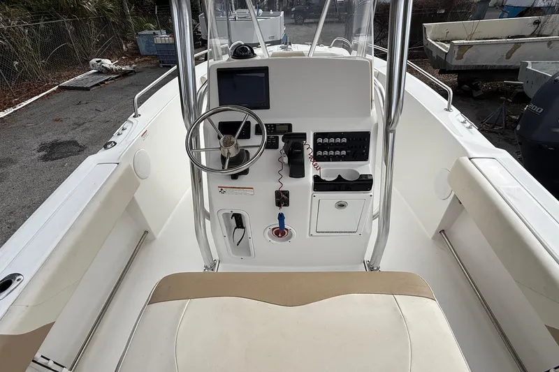 Slide: The Image of 2020 Edgewater 208CC boat console with steering wheel and control panel. - 11