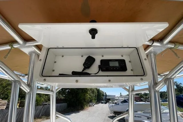 Slide: The Image of 2020 Edgewater 208CC boat console with radio and microphone in storage compartment. - 15