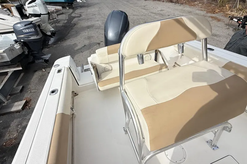 Slide: The Image of 2020 Edgewater 208CC boat interior with beige seating and Yamaha outboard motor. - 17