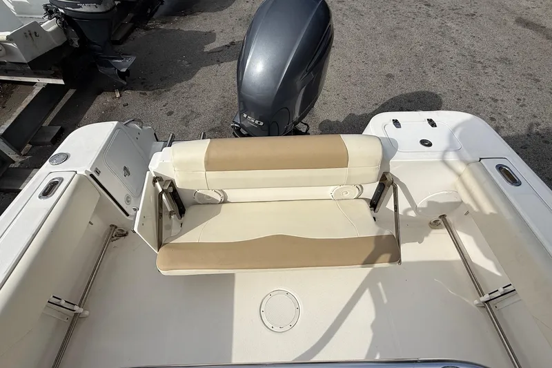 Slide: The Image of 2020 Edgewater 208CC boat interior with beige seating and outboard motor. - 19