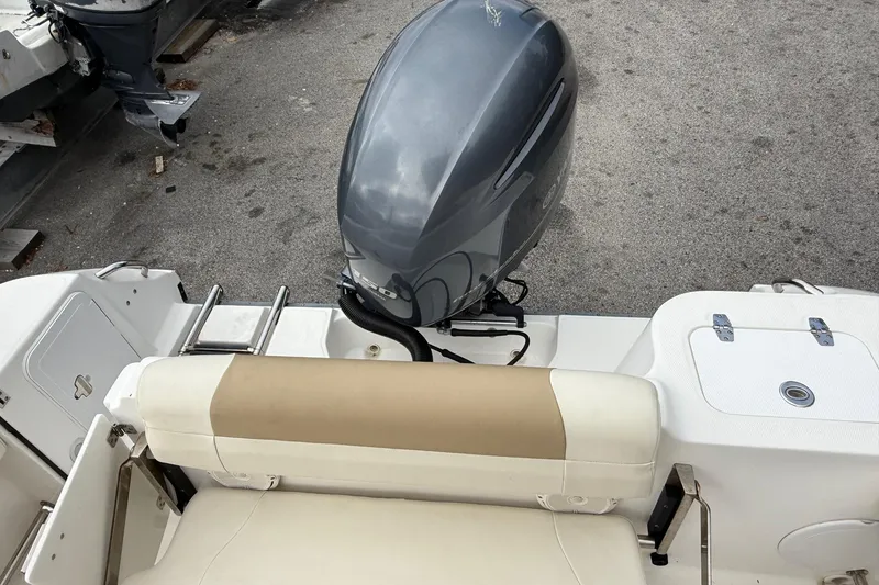Slide: The Image of 2020 Edgewater 208CC boat with outboard motor and beige seating. - 20
