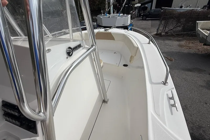 Slide: The Image of 2020 Edgewater 208CC boat interior with stainless steel railings and seating area. - 22