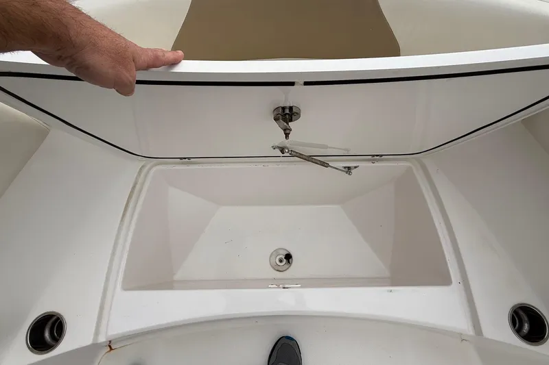 Slide: The Image of Open storage compartment on a 2020 Edgewater 208CC boat, showing interior details. - 25
