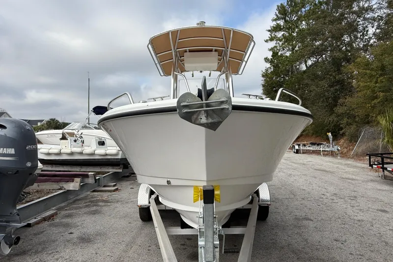 Slide: The Image of 2020 Edgewater 208CC boat on trailer, with Yamaha engine, parked outdoors. - 7