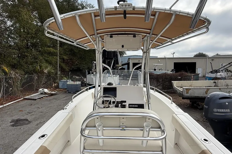 Slide: The Image of 2020 Edgewater 208CC boat with Yamaha engine, parked outdoors near industrial buildings. - 9