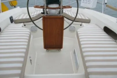 Slide: The Image of 1989 Sabre 34 MK II sailboat cockpit with striped seating and wooden helm. - 3