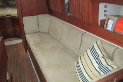 Slide: The Image of 1989 Sabre 34 MK II yacht interior with beige sofa and striped pillow. - 7