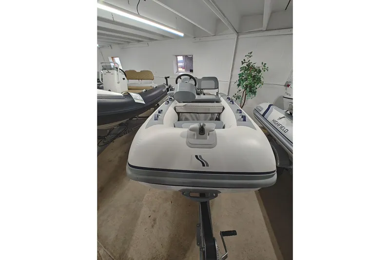 The Image of 2021 Highfield Classic 310 FCT inflatable boat in showroom setting. - 1