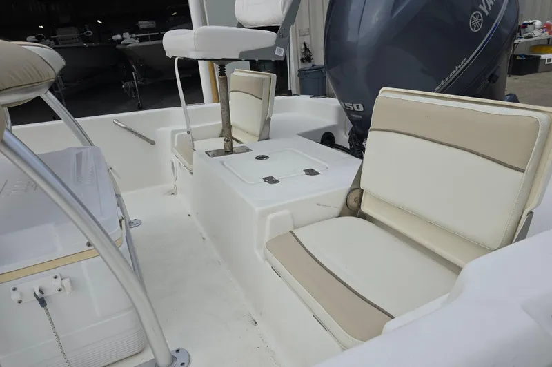 Slide: The Image of 2018 NauticStar 2140 Sport boat interior with seating and Yamaha engine. - 11