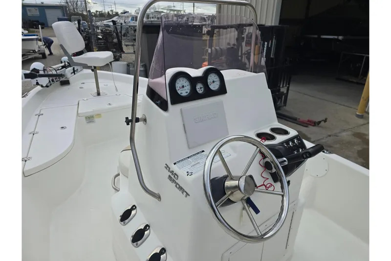 Slide: The Image of 2018 NauticStar 2140 Sport boat console with steering wheel and gauges. - 12
