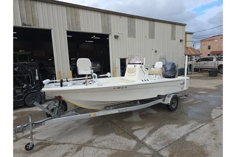 Slide: The Image of 2018 NauticStar 2140 Sport boat on trailer outside a warehouse. - 3