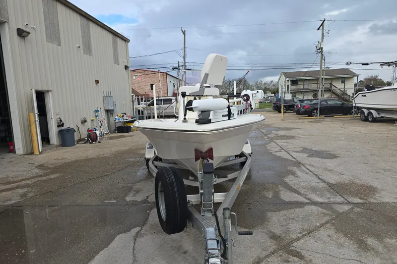 Slide: The Image of 2018 NauticStar 2140 Sport boat on trailer in a parking lot. - 4