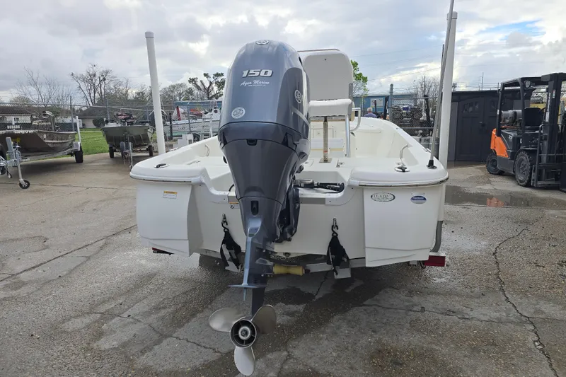 Slide: The Image of 2018 NauticStar 2140 Sport boat with Yamaha 150 engine, parked outdoors. - 8