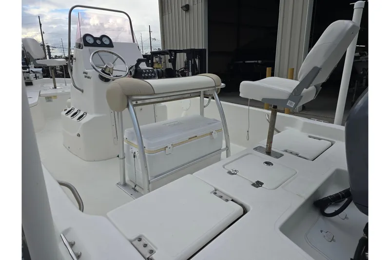 Slide: The Image of 2018 NauticStar 2140 Sport boat interior with steering console and seating. - 9