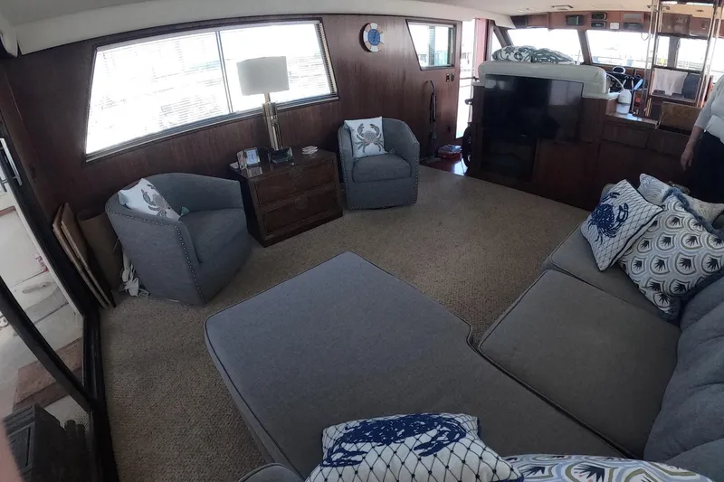 Slide: The Image of Interior of 1987 Hatteras 54 Motor Yacht with cozy seating and nautical decor. - 10