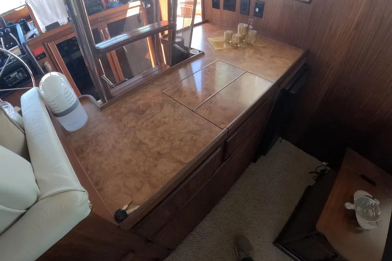 Slide: The Image of 1987 Hatteras 54 Motor Yacht interior with wooden cabinetry and countertop. - 13