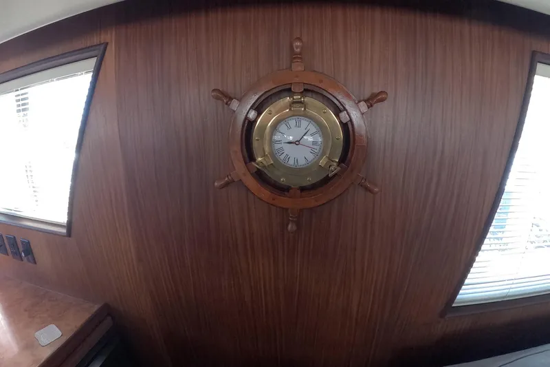 Slide: The Image of Wall-mounted nautical clock on 1987 Hatteras 54 Motor Yacht interior. - 14
