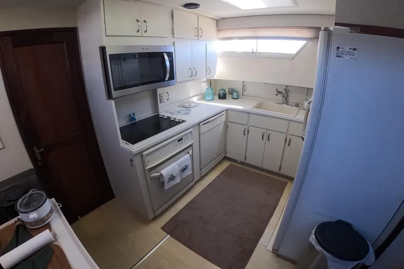 Slide: The Image of 1987 Hatteras 54 Motor Yacht kitchen with modern appliances and ample storage. - 18