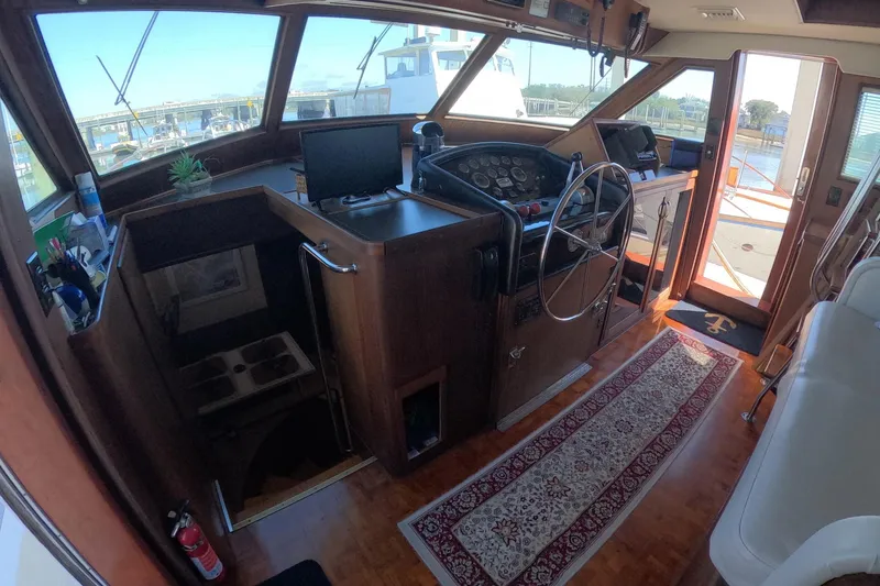 Slide: The Image of 1987 Hatteras 54 Motor Yacht interior with helm, steering wheel, and navigation equipment. - 2