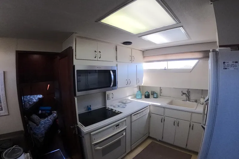 Slide: The Image of 1987 Hatteras 54 Motor Yacht kitchen with modern appliances and ample storage. - 21
