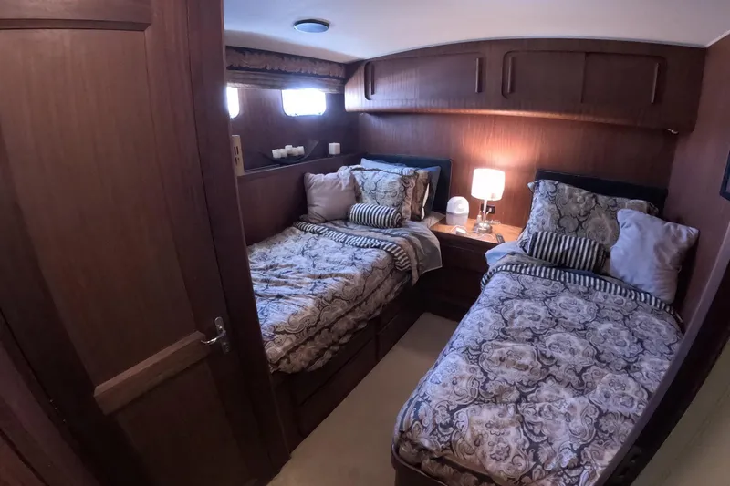 Slide: The Image of Interior of 1987 Hatteras 54 Motor Yacht with twin beds and elegant decor. - 22