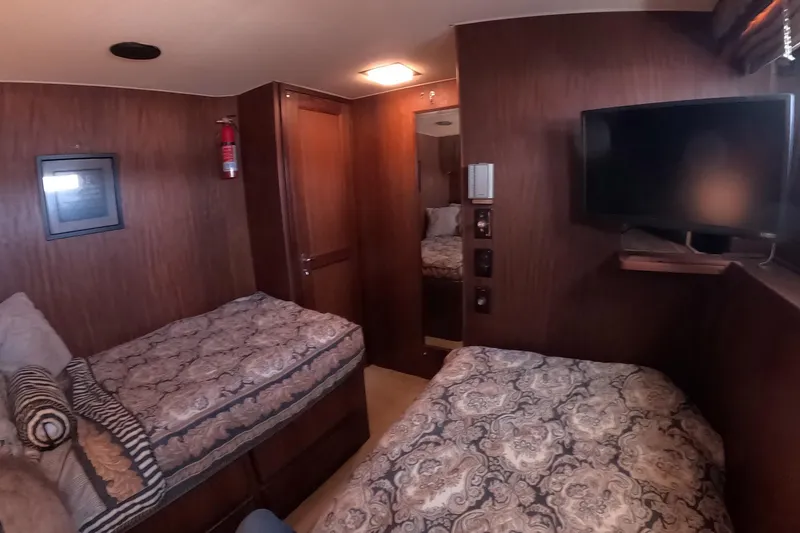 Slide: The Image of Interior of 1987 Hatteras 54 Motor Yacht with twin beds and TV. - 23