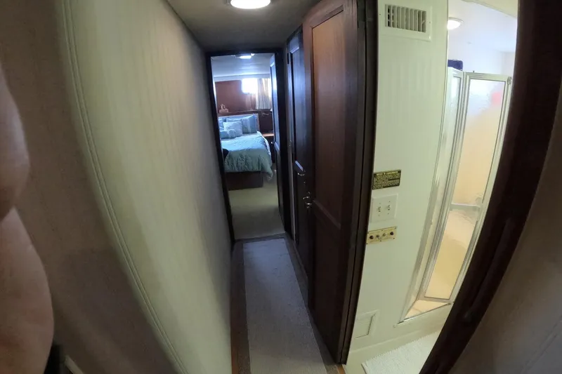 Slide: The Image of Narrow hallway in 1987 Hatteras 54 Motor Yacht with bedroom and bathroom view. - 25