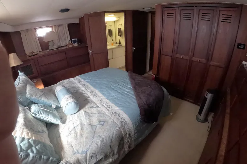 Slide: The Image of Cozy bedroom in 1987 Hatteras 54 Motor Yacht with elegant bedding and wooden cabinetry. - 27