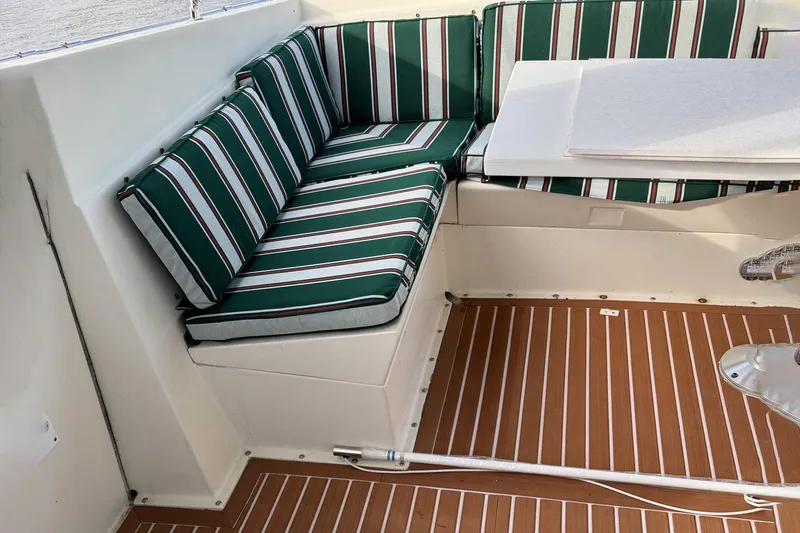 Slide: The Image of 1987 Hatteras 54 Motor Yacht interior with striped seating and wooden flooring. - 40