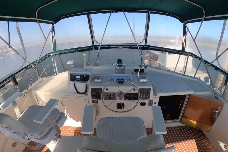 Slide: The Image of 1987 Hatteras 54 Motor Yacht helm with steering wheel and navigation equipment. - 43