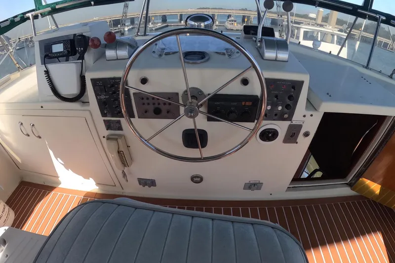 Slide: The Image of 1987 Hatteras 54 Motor Yacht helm with steering wheel and control panel. - 44