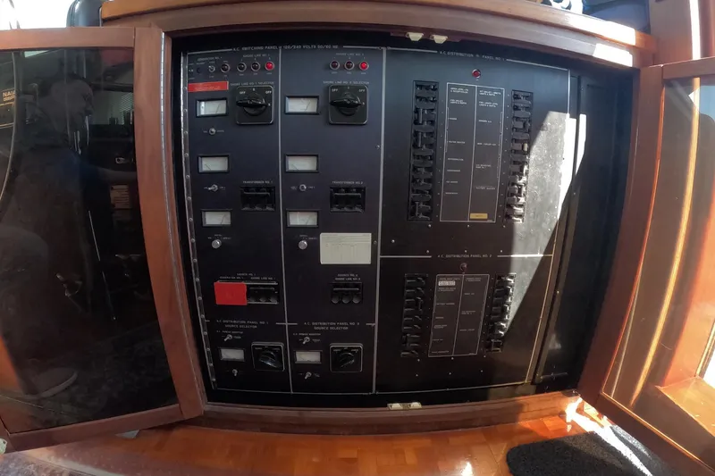 Slide: The Image of Electrical control panel on a 1987 Hatteras 54 Motor Yacht, featuring switches and gauges. - 53