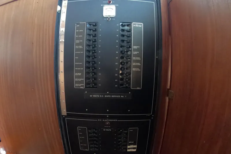 Slide: The Image of Electrical panel on 1987 Hatteras 54 Motor Yacht, featuring switches and controls. - 54