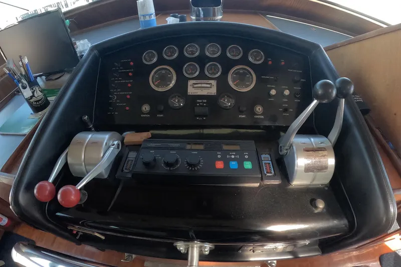 Slide: The Image of Control panel of a 1987 Hatteras 54 Motor Yacht with gauges and levers. - 55