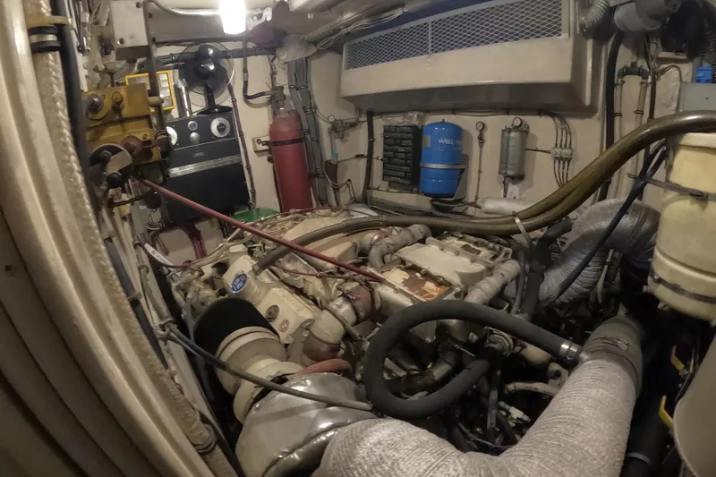 Slide: The Image of Engine room of a 1987 Hatteras 54 Motor Yacht, showcasing mechanical components. - 62