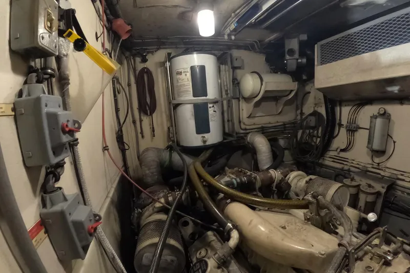 Slide: The Image of Engine room of a 1987 Hatteras 54 Motor Yacht, showcasing mechanical components. - 67