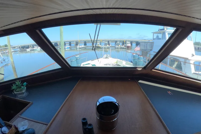 Slide: The Image of Interior view from 1987 Hatteras 54 Motor Yacht, overlooking marina through large windows. - 7