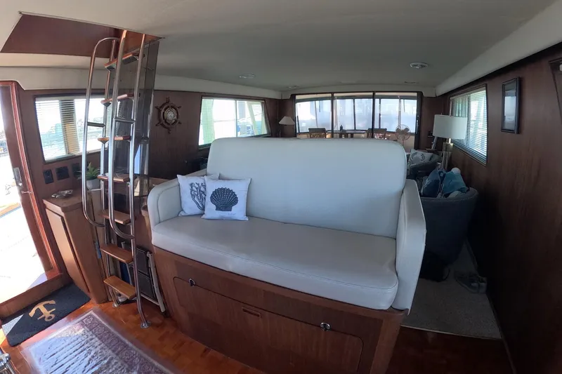 Slide: The Image of Interior of 1987 Hatteras 54 Motor Yacht with cozy seating and nautical decor. - 8