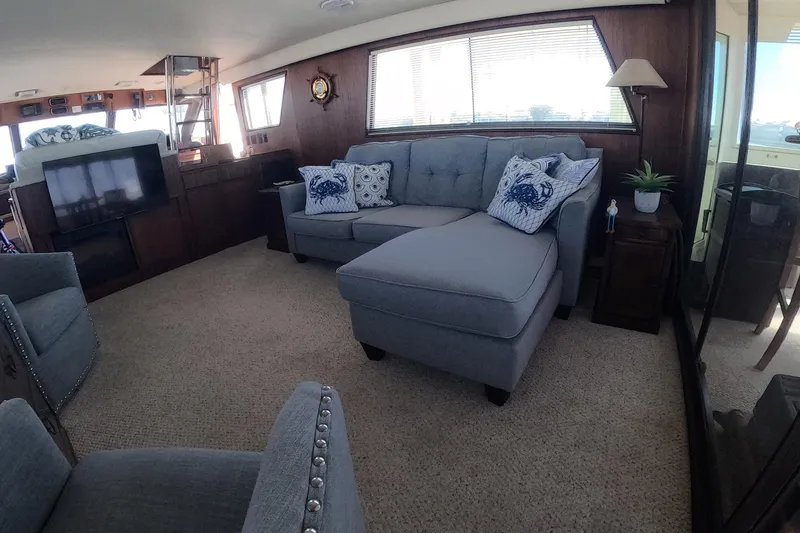 Slide: The Image of Luxurious interior of 1987 Hatteras 54 Motor Yacht with elegant seating and nautical decor. - 9
