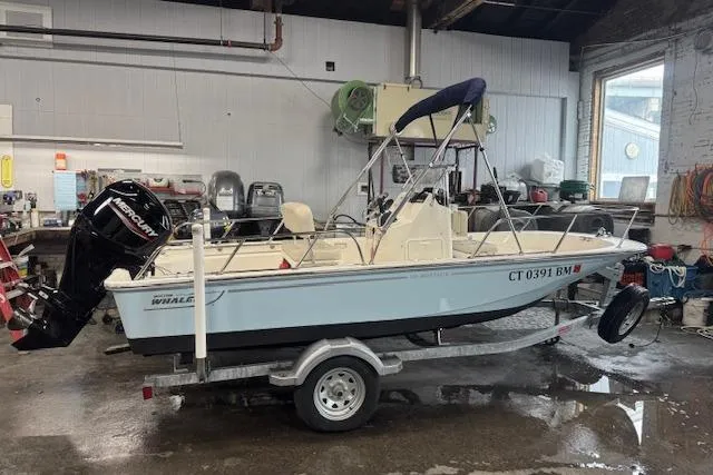 The Image of 2024 Boston Whaler 150 Montauk boat on trailer in a garage setting. - 0