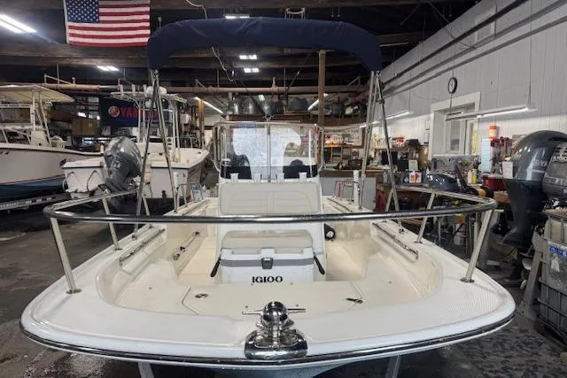 Slide: The Image of 2024 Boston Whaler 150 Montauk boat in a workshop, featuring a sleek design and sturdy build. - 2