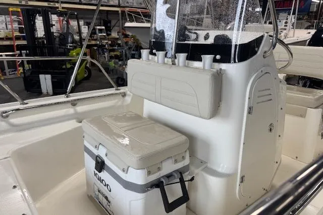 Slide: The Image of 2024 Boston Whaler 150 Montauk interior with seating and storage features. - 5