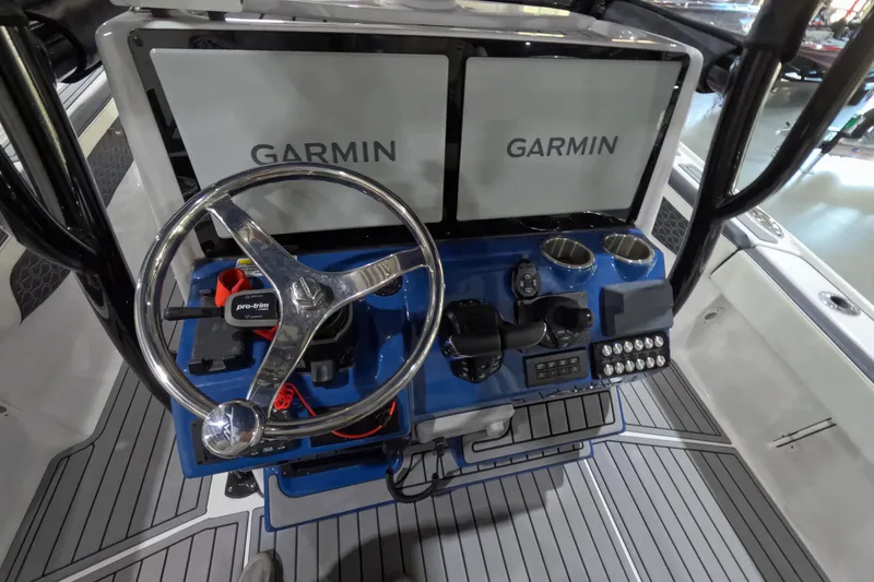 Slide: The Image of 2024 Tidewater boat dashboard with Garmin displays and steering wheel. - 13