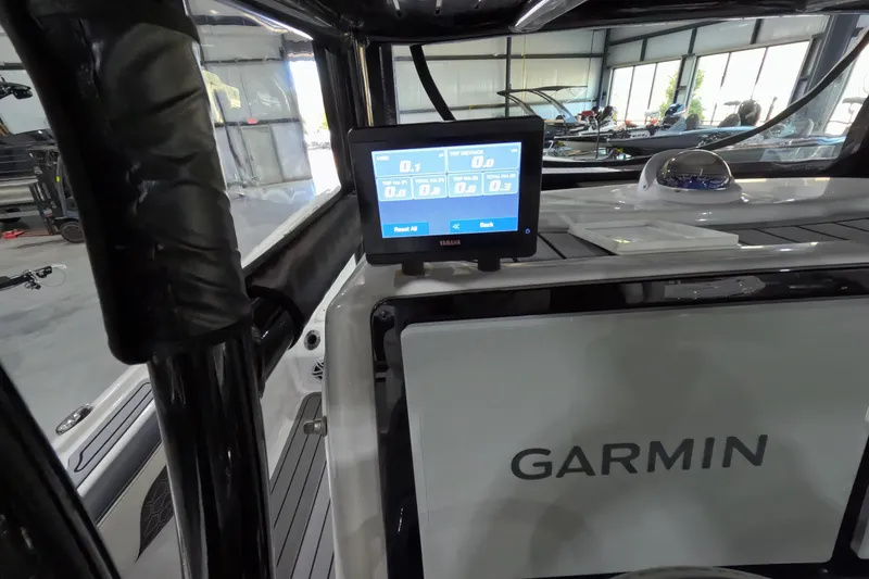 Slide: The Image of 2024 Tidewater boat with Garmin navigation system and Yamaha display in a showroom. - 14