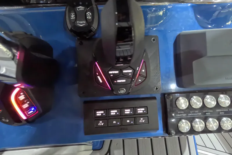Slide: The Image of 2024 Tidewater boat control panel with illuminated buttons and switches. - 17
