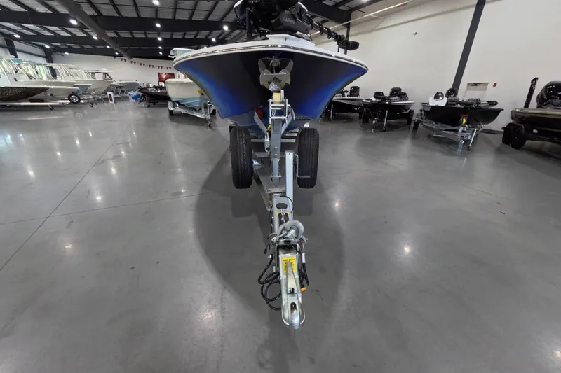 Slide: The Image of 2024 Tidewater boat on trailer in showroom, surrounded by other boats. - 4