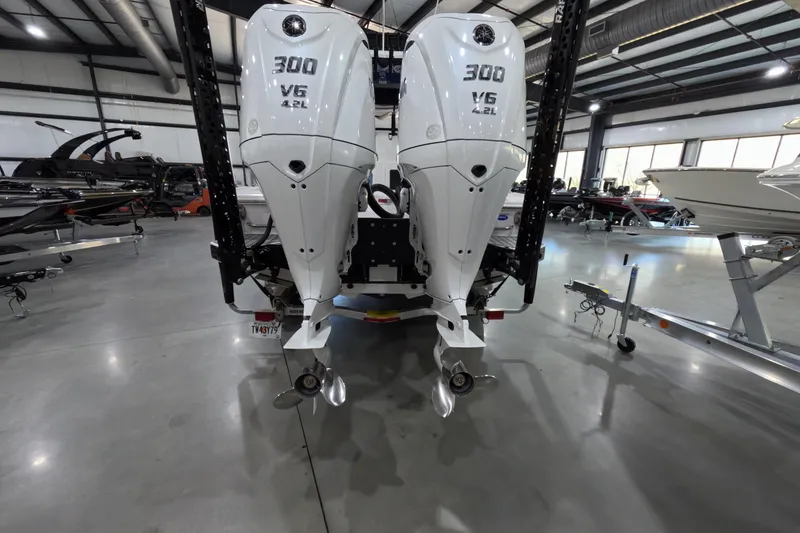 Slide: The Image of 2024 Tidewater boat with dual 300 V6 outboard engines in a showroom. - 5